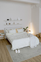 Bed in the bedroom. White bed linen and pillows. Interior of the house.
