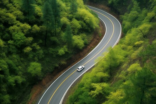 High Angle View Of The Road In The Forest With Car Driving On It