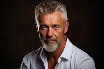 Fototapeta premium Portrait of a gray-haired man with a beard and a white shirt