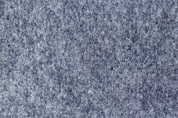 Detail of thick gray fabric texture. You can see the white and gray threads that make it up and its chaos.
