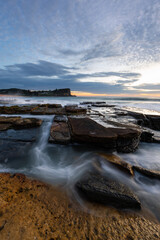 Ocean water flowing between rock formation at Avalon Beach, Sydney, Australia.