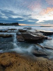 Ocean water flowing between rock formation at Avalon Beach, Sydney, Australia.
