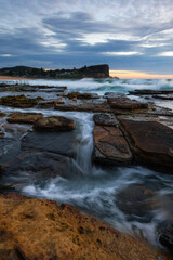 Fototapeta na wymiar Ocean water flowing between rock formation at Avalon Beach, Sydney, Australia.