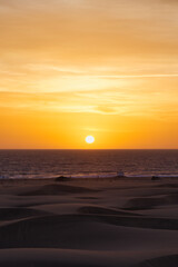Fototapeta premium Asian Girl looking sunrise in Maspalomas. Spanish sunrise in Spain. Gran Canaria Sunrise and sunsets. 