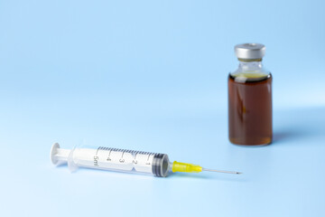 syringe for injectable medication on blue background