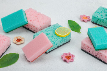 Obraz na płótnie Canvas Various sponges for washing dishes. Organic cleaning concept, lemon freshness. Stone background