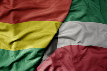 big waving national colorful flag of kuwait and national flag of bolivia .