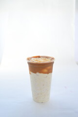Panoramic still life of colorful frozen fruit granita drinks flowing in plastic takeaway cups with ice cream straws