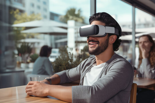 Young adult man using vision reality headset in public cafe, Virtual and Augmented, Watching Video in daily life with virtual digital gadget goggles. Adult wearing VR headset. Simulator