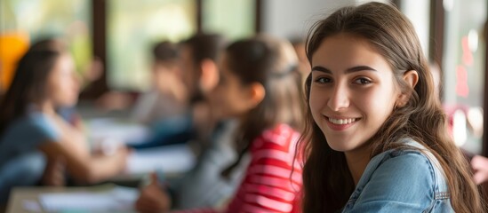 Teen girl learning in classroom with instructor.