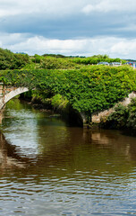 Fototapeta na wymiar Stone bridge across Owenavorragh River in Courtown in Co Wexford, Ireland 