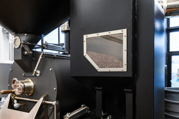 Black industrial coffee roaster close-up photo