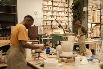 African ceramists working with molds in a pottery workshop