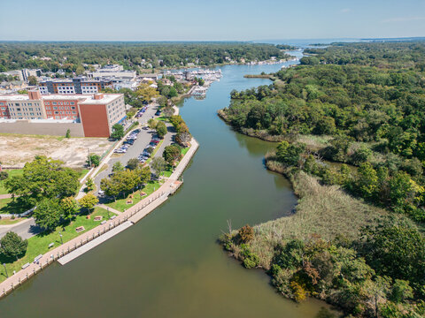 Aerial overhead view of the town of Riverhead New York located in Suffolk County on Long Island with buildings, waterway and boats