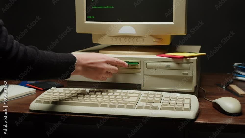 Wall mural using diskette fdd for old computer close-up. hand inserting and ejecting floppy disk into vintage p