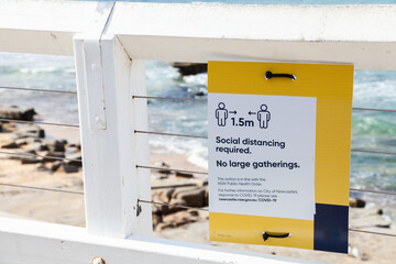 1.5m social distancing required and no large gatherings sign