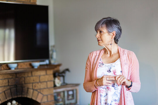 Oder woman looking to the side with copy space in her living room