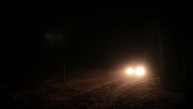 Night Drive: Slow-Moving Car on Countryside Road with Flashing Headlights