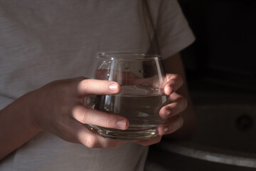 A glass of clean water in a child's hand