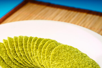 Green avocado chips on a plate