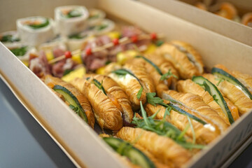 Cold snacks, rolls, ham and pastries were delivered in a cardboard box.