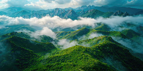 Panoramic view of lush green mountain ranges under a dramatic sky, showcasing the vast beauty of a natural landscape.