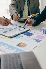 Portrait of business consultants meeting in their office and brainstorming about financial investments, new projects, and business data calculations. Accounting documents and laptop computers