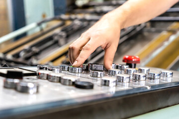 close up engineer hand finger press button controling cnc machine, Workers operating factory machinery in warehouse