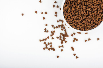 Dry pet food in a bowl isolated on white background