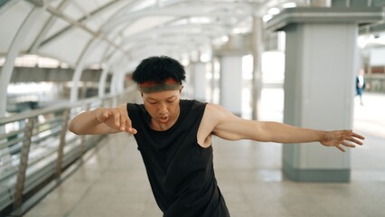 Smart handsome dancer moving hands while dance to hip hop music. Professional asian hipster wearing...