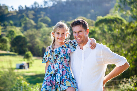 Portrait of father and daughter together on farm