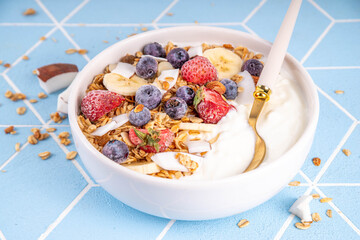 Breakfast yogurt granola bowl with fruit and berry