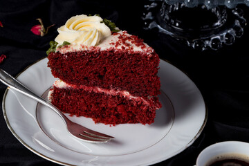 Gourmet Red Velvet Cake Adorned with Delicate Cream Flowers, perfect for an elegant dinner setting