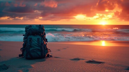 Backpack on Sandy Beach at Sunset - obrazy, fototapety, plakaty