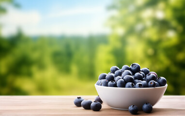 Summer copy space banner with blueberries in the bowl with garden background.