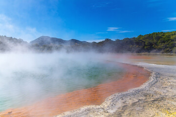 View of the azure hot water pond in New Zealand. Capturing the natural beauty of geothermal wonders, ideal for travel brochures, wellness concepts, or any project highlighting unique landscapes.