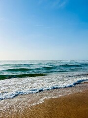Seashore background, sea horizon, sea foam at the sandy coast