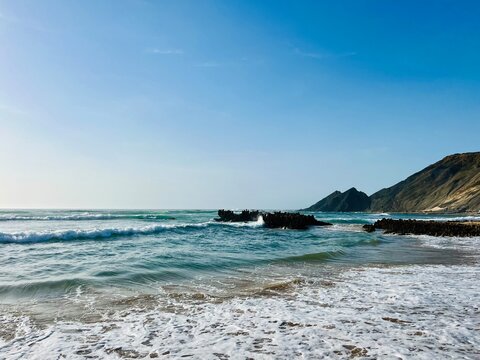 Rocky ocean coast, ocean bay, blue sky