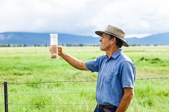 Farmer checking rain in bureau of meteorology rain gauge