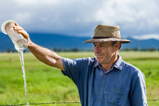 Farmer checking rain in bureau of meteorology rain gauge