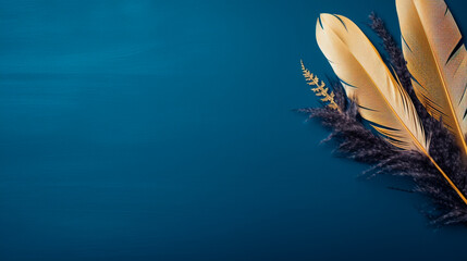 a feather resting on a plant against a blue wall