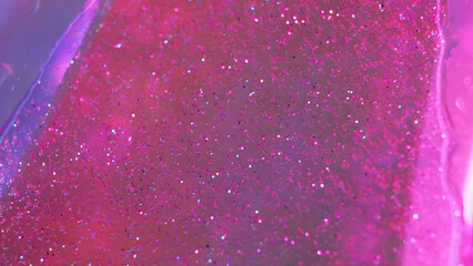 Glitter gel drip. Fluid spill. Defocused pink violet color transparent sparkling particles texture oil paint wave flow motion abstract art background.