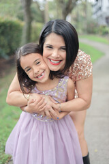 Mother and daughter mothers day photo in a park walking and playing 