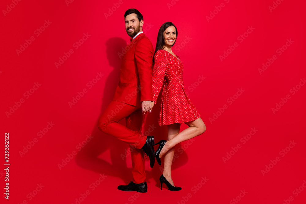 Aufkleber Full length profile portrait of two classy positive soulmates stand back to back hold arms empty space isolated on red color background