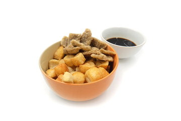 a bowl full of pempek and cuko sauce