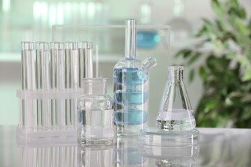 Laboratory analysis. Different glassware with liquid on white table indoors