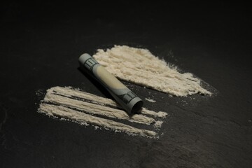 Drug addiction. Cocaine and rolled dollar banknote on grey textured table, closeup - obrazy, fototapety, plakaty