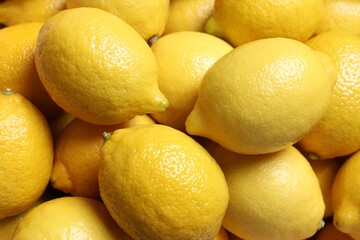 Fresh lemons as background, closeup. Citrus fruit