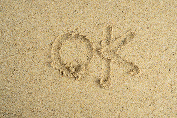 sand with ok text
