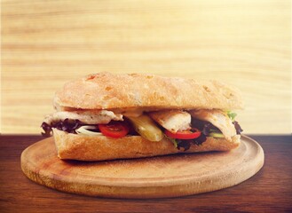 Tasty fresh sandwich with herbs on the desk